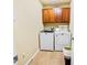 Laundry room with washer, dryer, and cabinets at 6932 Vintage Ln, Port Orange, FL 32128