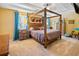 Spacious main bedroom with a large four-poster bed and carpeted floor at 6932 Vintage Ln, Port Orange, FL 32128