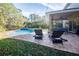 Relaxing patio with seating and pool view at 6932 Vintage Ln, Port Orange, FL 32128