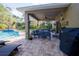 Covered patio with comfortable seating and grill at 6932 Vintage Ln, Port Orange, FL 32128