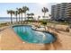 Relaxing oceanfront pool and spa area with lounge chairs at 701 N Atlantic Ave # 102, New Smyrna Beach, FL 32169