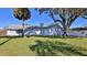 Spacious backyard with lush lawn and mature trees at 752 Tarry Town Trl, Port Orange, FL 32127