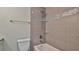 Bathroom with tiled shower and glass shelving at 752 Tarry Town Trl, Port Orange, FL 32127