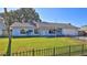 Ranch style home with a light blue exterior and a spacious lawn at 752 Tarry Town Trl, Port Orange, FL 32127
