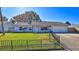 Charming light blue house with a grassy front yard and black fence at 752 Tarry Town Trl, Port Orange, FL 32127