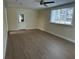 Living room with wood-look floors and access to the backyard at 795 Biro Dr, Port Orange, FL 32129