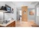 Bright entryway with hardwood console table and art at 803 Silk Oak Ct, New Smyrna Beach, FL 32168