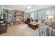 Living room with brick fireplace, built-in shelving, and hardwood floors at 803 Silk Oak Ct, New Smyrna Beach, FL 32168