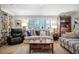 Cozy living room featuring a comfortable sofa, built-in shelving, and hardwood floors at 803 Silk Oak Ct, New Smyrna Beach, FL 32168