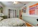 Bright bedroom with leafy bedding, built-in shelves, and wood floors at 810 E 9Th Ave, New Smyrna Beach, FL 32169