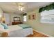 Light and airy bedroom with wood floors and dresser at 810 E 9Th Ave, New Smyrna Beach, FL 32169