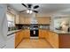 U-shaped kitchen featuring granite countertops and wood cabinets at 810 E 9Th Ave, New Smyrna Beach, FL 32169