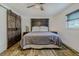 Main bedroom with rustic wood sliding doors and ceiling fan at 814 E 20Th Ave, New Smyrna Beach, FL 32169