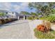 Long driveway leading to a charming house with lush landscaping on a sunny day at 814 E 20Th Ave, New Smyrna Beach, FL 32169