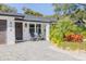 Welcoming front porch with two chairs and attractive landscaping at 814 E 20Th Ave, New Smyrna Beach, FL 32169