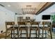 Kitchen island with granite countertop and four wooden chairs at 814 E 20Th Ave, New Smyrna Beach, FL 32169