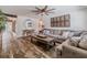 Living room with hardwood floors, sectional sofa, and a ceiling fan at 814 E 20Th Ave, New Smyrna Beach, FL 32169