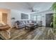 Spacious living room featuring a large sectional sofa, hardwood floors, and a ceiling fan at 814 E 20Th Ave, New Smyrna Beach, FL 32169