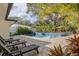 Relaxing pool area with patio furniture and lush landscaping at 814 E 20Th Ave, New Smyrna Beach, FL 32169