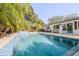 Inviting pool with a waterfall feature and lounge chairs at 814 E 20Th Ave, New Smyrna Beach, FL 32169