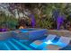 Lighted pool and spa with lounge chairs at night at 814 E 20Th Ave, New Smyrna Beach, FL 32169