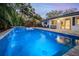 Inviting lighted pool with waterfall feature at dusk at 814 E 20Th Ave, New Smyrna Beach, FL 32169