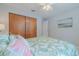 Bright bedroom with a leafy patterned bedspread and wood sliding doors at 826 E 12Th Ave, New Smyrna Beach, FL 32169