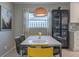 Bright dining area with a white table and yellow chairs at 826 E 12Th Ave, New Smyrna Beach, FL 32169