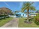 Charming light blue single story home with a mature palm tree and a well manicured lawn at 826 E 12Th Ave, New Smyrna Beach, FL 32169