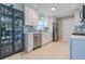 Modern white kitchen with stainless steel appliances and blue tile backsplash at 826 E 12Th Ave, New Smyrna Beach, FL 32169