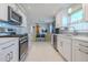 Modern kitchen with white cabinets, stainless steel appliances, and a stylish backsplash at 826 E 12Th Ave, New Smyrna Beach, FL 32169