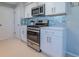 Modern kitchen with stainless steel appliances and white cabinets at 826 E 12Th Ave, New Smyrna Beach, FL 32169