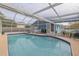 Inviting pool area with screened enclosure, patio furniture, and ample space for relaxation at 826 E 12Th Ave, New Smyrna Beach, FL 32169