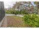 Landscaped side yard with privacy fence and mature trees at 826 E 12Th Ave, New Smyrna Beach, FL 32169