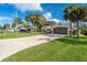 House exterior view, landscaped yard, and brick driveway at 831 Evergreen St, New Smyrna Beach, FL 32169