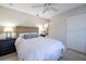 Cozy bedroom with queen bed and ceiling fan at 831 Evergreen St, New Smyrna Beach, FL 32169