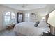 Bright bedroom with queen-size bed and arched window with shutters at 831 Evergreen St, New Smyrna Beach, FL 32169