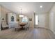 Bright dining room features a round wooden table with beige chairs and a rustic hutch at 831 Evergreen St, New Smyrna Beach, FL 32169