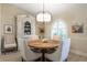 Charming dining room with a round wooden table, beige chairs, and a white hutch at 831 Evergreen St, New Smyrna Beach, FL 32169