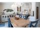 Dining room with farmhouse table and view of kitchen at 831 Evergreen St, New Smyrna Beach, FL 32169