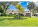 Front yard with lush landscaping and walkway at 831 Evergreen St, New Smyrna Beach, FL 32169