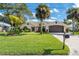 Single-story home with landscaped yard and attached garage at 831 Evergreen St, New Smyrna Beach, FL 32169