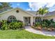 Home entrance with tropical landscaping at 831 Evergreen St, New Smyrna Beach, FL 32169