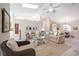 Bright living room features neutral sofas, a driftwood coffee table, and hardwood floors at 831 Evergreen St, New Smyrna Beach, FL 32169