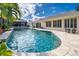 Freeform pool with stone coping and lush landscaping at 831 Evergreen St, New Smyrna Beach, FL 32169