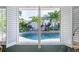 View of a refreshing pool area through open shutters at 831 Evergreen St, New Smyrna Beach, FL 32169