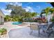 Pool and spa with patio furniture and lush landscaping at 831 Evergreen St, New Smyrna Beach, FL 32169