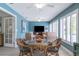 Sunroom with wicker dining set, a large TV, and pool view at 831 Evergreen St, New Smyrna Beach, FL 32169