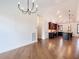 Bright dining room with hardwood floors and chandelier at 997 Sugar Mill Dr, New Smyrna Beach, FL 32168