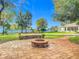 Charming backyard fire pit area with brick pavers and landscaping at 997 Sugar Mill Dr, New Smyrna Beach, FL 32168